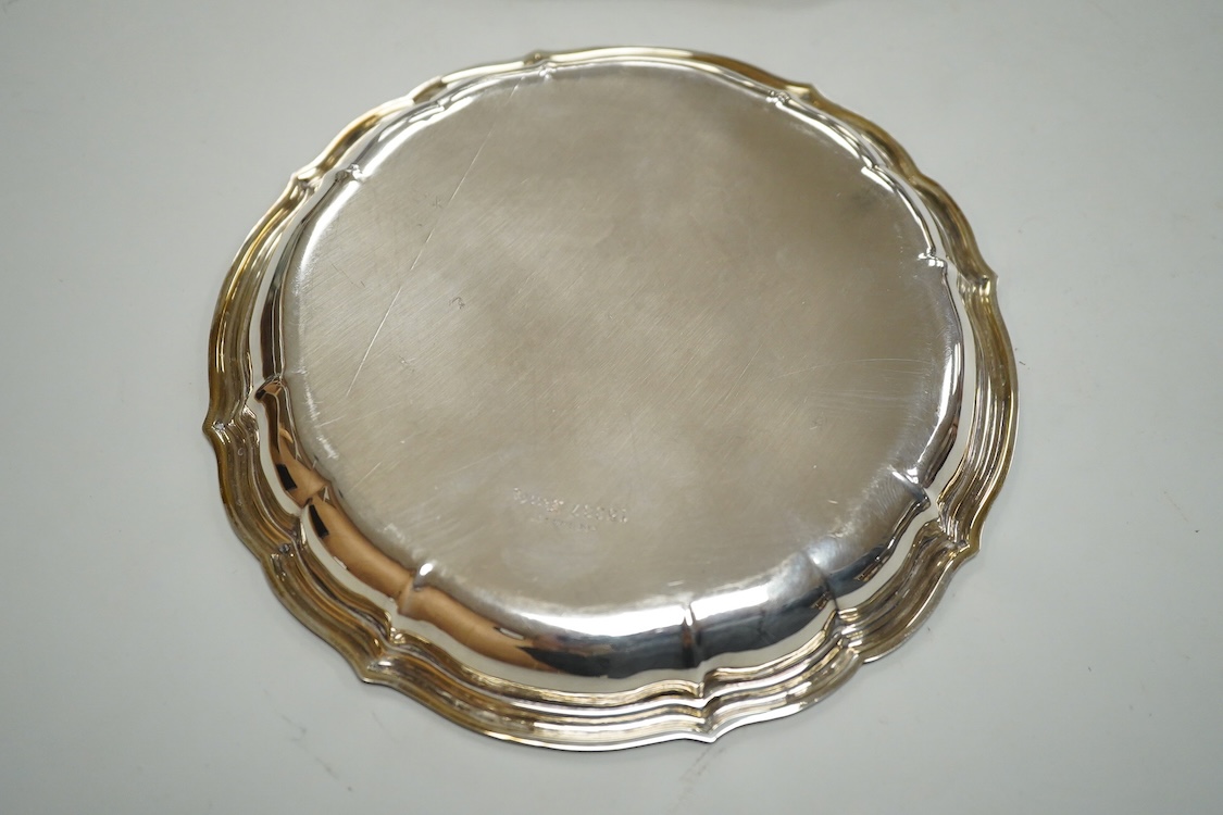A German 800 standard white metal salver, diameter 35.9cm, together with a similar waiter, diameter 15.6cm, both with engraved armorial, 35oz.
